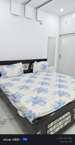 a bed with blue and white sheets and pillows at Graps Ocean Stay in Chīrāla
