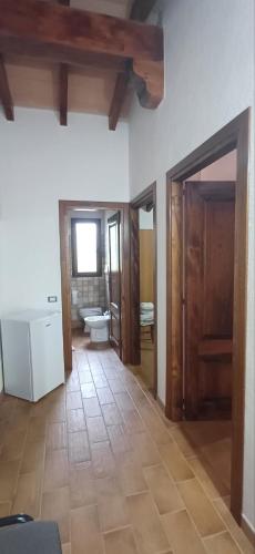 a room with a bathroom with a toilet and a sink at Agriturismo Funtan'Arva in Loculi
