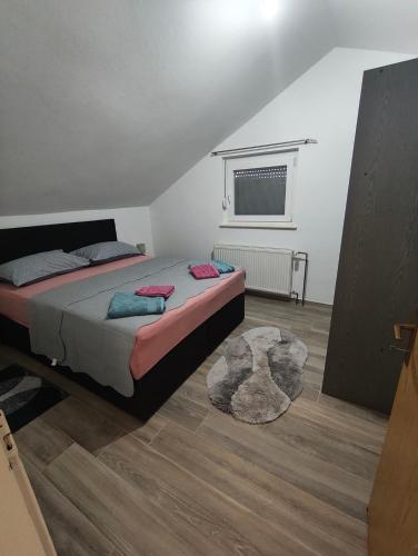 a bedroom with a bed and a rug at Apartment Velebit with swimming pool - 10km from sea - 20km from Zadar in Benkovac