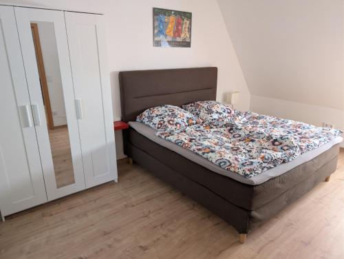 a bedroom with a bed and a closet at Ferienwohnung am Hainer Berg in Heigenbrücken