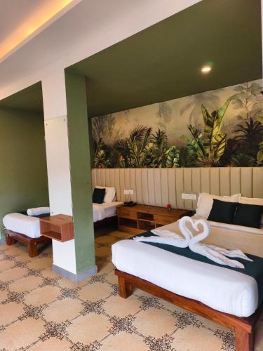 a room with two beds and a painting on the wall at Laalis crest Coorg Madikeri in Madikeri