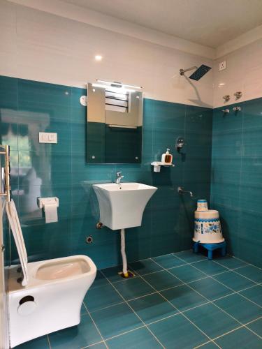 a bathroom with a sink and a toilet at Laalis crest Coorg Madikeri in Madikeri