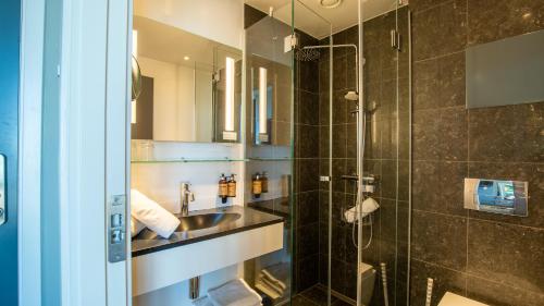 a bathroom with a sink and a shower at Best Western Plus Hotel Ilulissat in Ilulissat