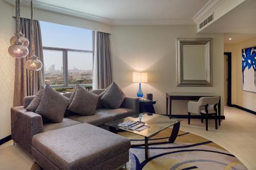 a living room with a couch and a table at Gulf Executive Residence in Manama