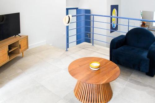 a living room with a couch and a coffee table at Villa Faraman au bord de l'eau in Le Grau-du-Roi