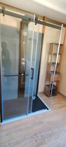 an open glass door with a lamp in a room at Gite De Baunac in Aubas