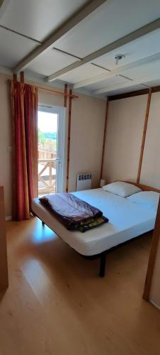 a large bed in a room with a window at Gite De Baunac in Aubas