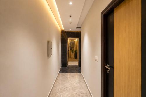 a hallway with a door leading into a room at Hotel Elev11 Near Ambala Chandigarh Highway, Zirakpur in Zirakpur