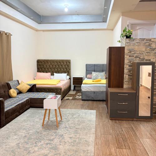 a living room with a couch and a bed at Studio near airport in Cairo