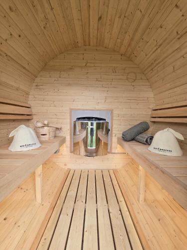 a room with two benches in a wooden room at Hot tub, Sauna, Derwen in Ruthin