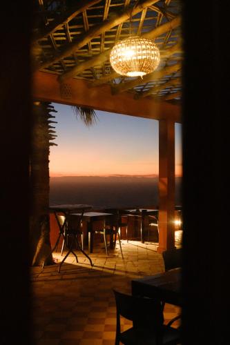 a view of the sunset from the deck of a restaurant at Le Nid d'Aigle in Mirleft