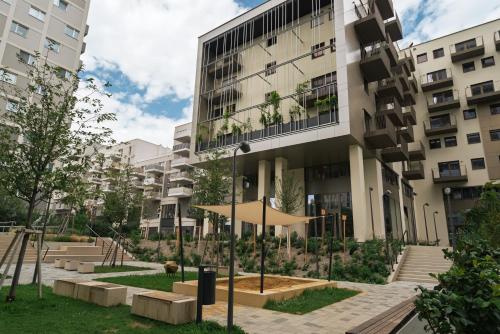 an apartment building with a courtyard in front of it at Habyt Vienna in Vienna