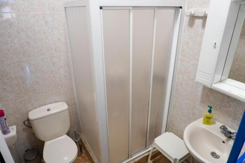 a bathroom with a toilet and a sink at Casa Argelio in Alojera