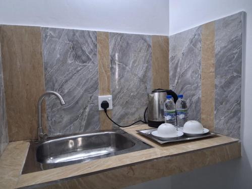 a kitchen counter with a sink and a coffee maker at Suzukis lagoon front in Katunayaka