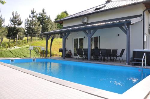 a swimming pool with a pavilion next to a house at Villa Saraj with Swimming Pool & Jacuzzi near Sarajevo in Sarajevo