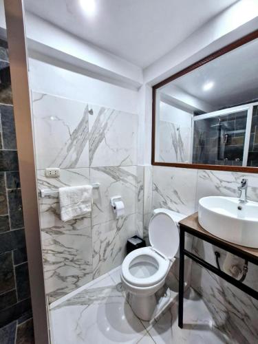 a bathroom with a toilet and a sink at Mirador de la Ñusta in Cusco