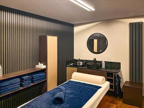a room with a bed and a vanity with a mirror at Morada Hotel Arendsee in Kühlungsborn