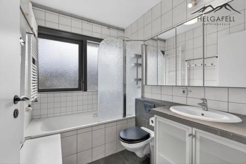 a white bathroom with a toilet and a sink at Kleppjárnsbraut in Kleppjárnsreykir