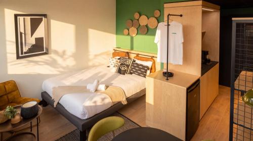 a bedroom with a bed in a room with green walls at Cowool Créteil in Créteil