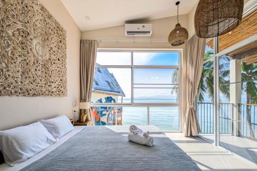 a bedroom with a bed and a large window at Happy Home kpg in Ko Phangan