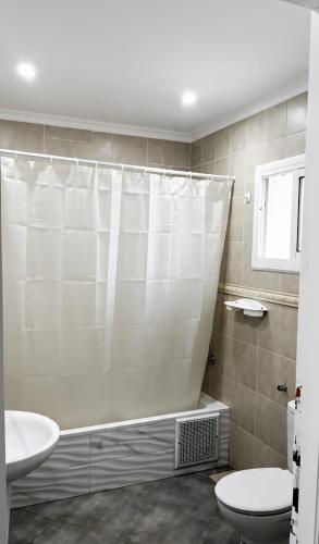 a bathroom with a shower curtain and a toilet at Dar Vista Mar in Tétouan