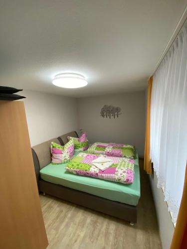 a bedroom with a bed with pillows on it at Ferienwohnung "Auszeit" in Dobra