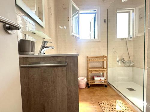 a small bathroom with a sink and a shower at White Sands 4.20 in Arenal d'en Castell