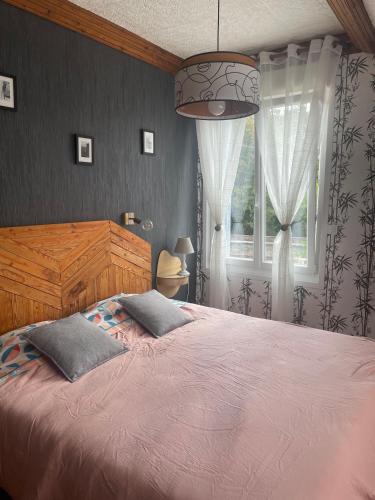 a bedroom with a large bed and a window at Une nuit près de l'eau in Hallines