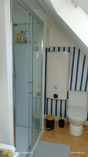 a bathroom with a toilet and a glass shower at Ty Penty in Riantec