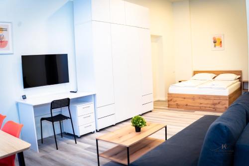 a living room with a couch and a bed at Urban76 Apartments in Târgu-Mureş