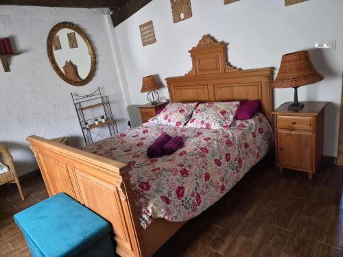 a bedroom with a large bed with a wooden frame at Casa Do Ivi in Yermo