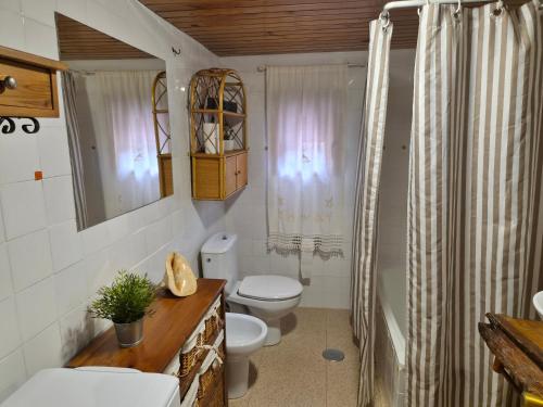 a bathroom with a toilet and a sink at Casa Do Ivi in Yermo