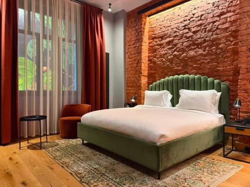 a bedroom with a bed and a brick wall at RUZ Hotels in Istanbul