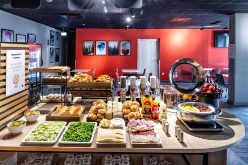 a buffet of food on a table in a store at B&B Hotel Maribor in Maribor