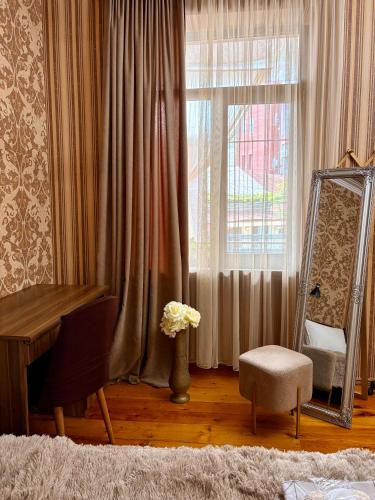 a room with a mirror and a table and a chair at SDD Brothers - Дом с балконом в сердце Тбилиси in Tbilisi City