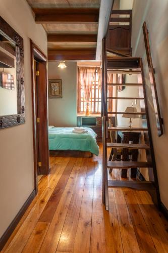 a bedroom with a bunk bed and a staircase at La POSADA CUENCANA EN CUENCA in Cuenca