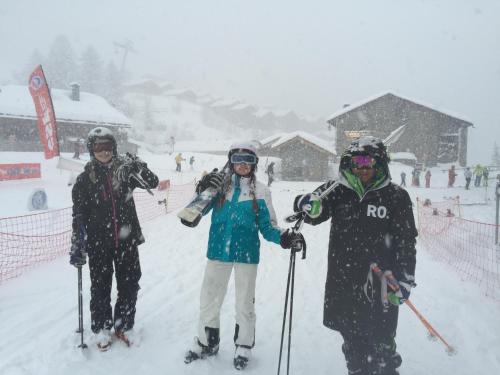 three people on skis standing in the snow at Black Diamond Sainte Foy Chalets in Sainte-Foy-Tarentaise
