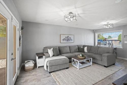 a living room with a gray couch and a table at Tucson Oasis by Rather Be Properties in Tucson