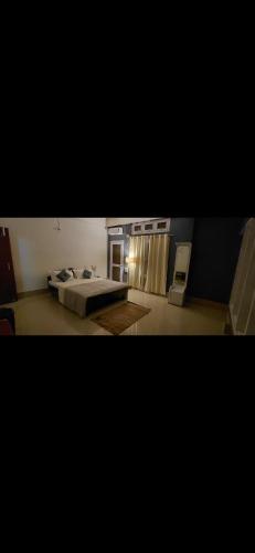 a bedroom with a bed and a table in it at Pipits cozynest in Tezpur
