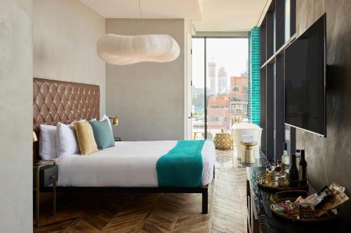 a bedroom with a large bed and a large window at Arlo Williamsburg in Brooklyn