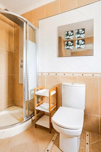 a bathroom with a toilet and a shower at Villa Amare in Benissa