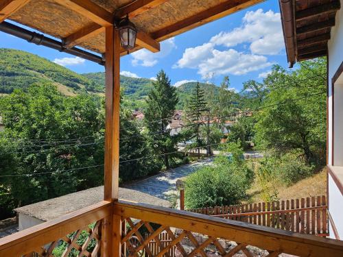 a view from the balcony of a cabin with a river at къща Чипровка in Chiprovtsi