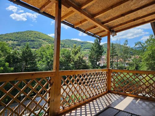 a view from the deck of a cabin with mountains in the background at къща Чипровка in Chiprovtsi