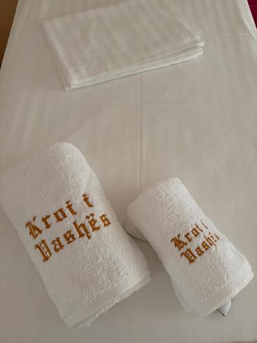 two white towels with the words happy new year on them at Villa Kroi i Vashes in Peqin