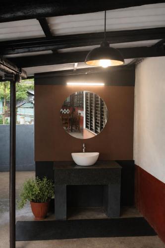 a bathroom with a sink and a mirror at Udupi River Inn in Kalyānpur