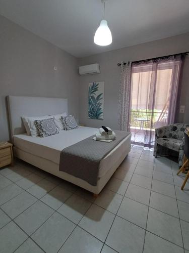 a bedroom with a large bed and a large window at Nini's House 2 Nydri - 100m from beach NYDRI TOWN CENTER in Nydri