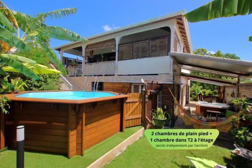 a house with a swimming pool in the yard at Jaden Kreyol - Gîte central, spa, piscine, BBQ in Lamentin