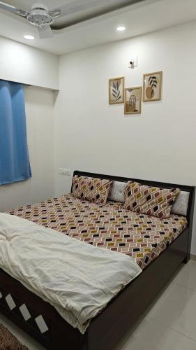 a large bed in a room with at 2bhk penthouse with open tarace in Vadodara