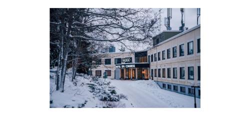 a snow covered street in a city with buildings at Hotel Haikko Manor & Spa in Porvoo