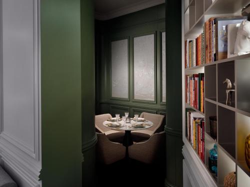 a small table in a room with a book shelf at Kempinski The Boulevard Dubai in Dubai